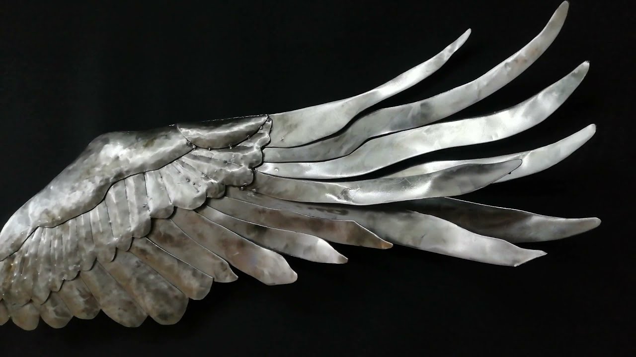 escultura metal pared